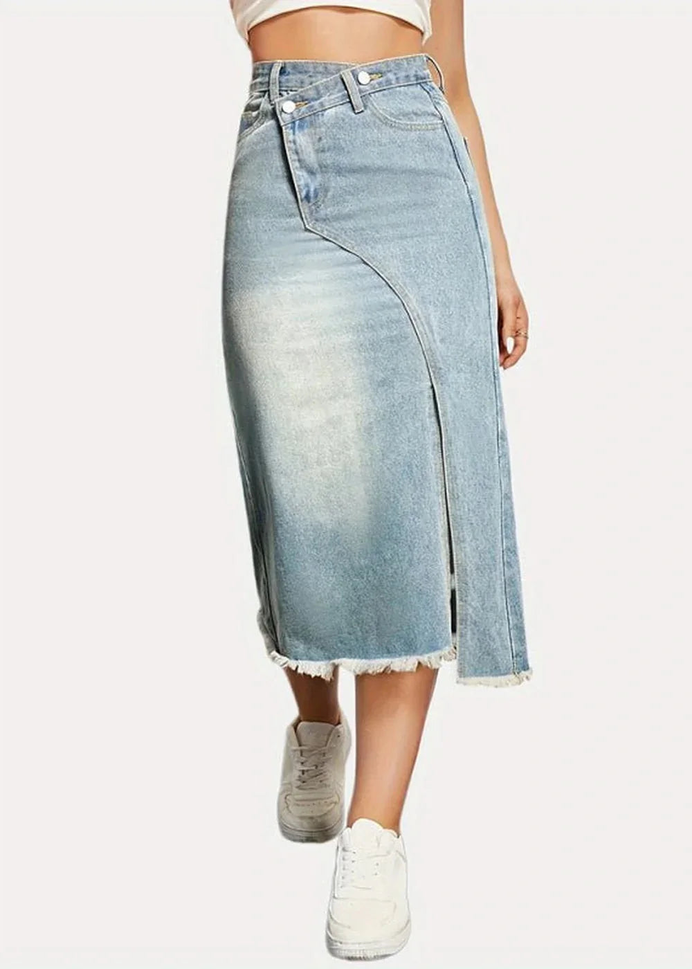 Light blue denim midi skirt with a frayed hem and a high slit, on model.