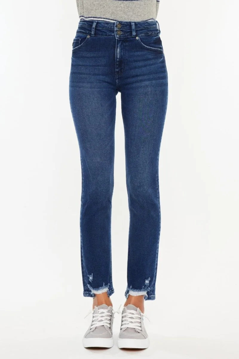 Dark wash denim jeans with frayed hem and gray sneakers.