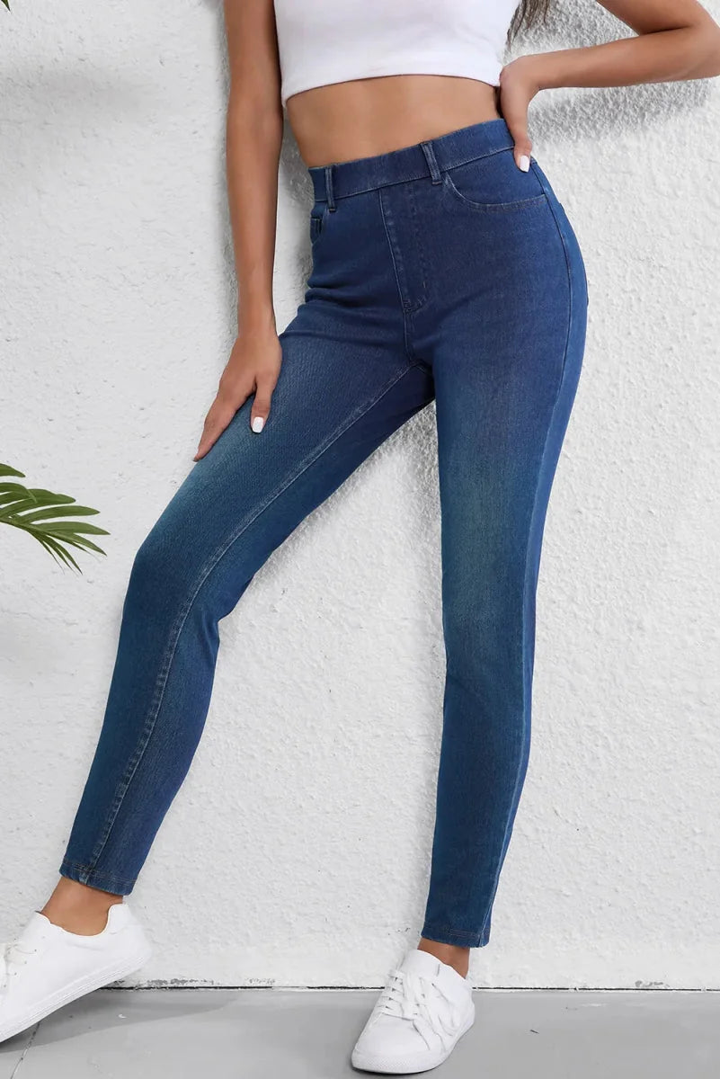 Navy blue denim jeans with a regular fit, detailed with a subtle fade and textured seams.