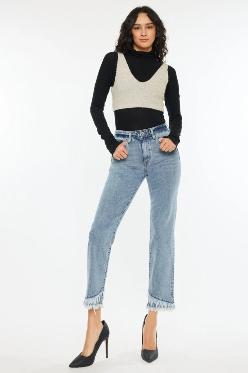 Light wash straight leg jeans with frayed hems on a model.