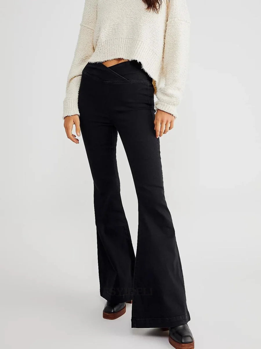 Black flare jeans with a V-shaped waist detail and platform shoes on model.