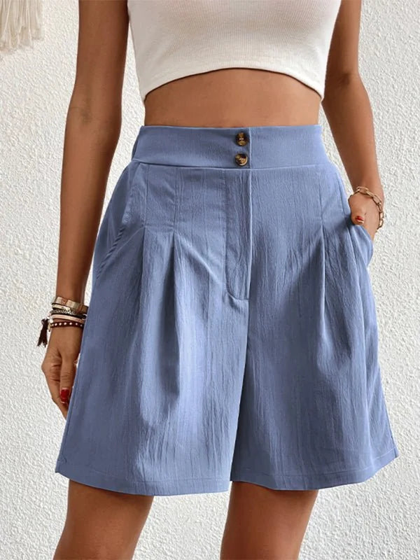 Light blue pleated shorts with a textured fabric and button-fly closure, shown on a model.