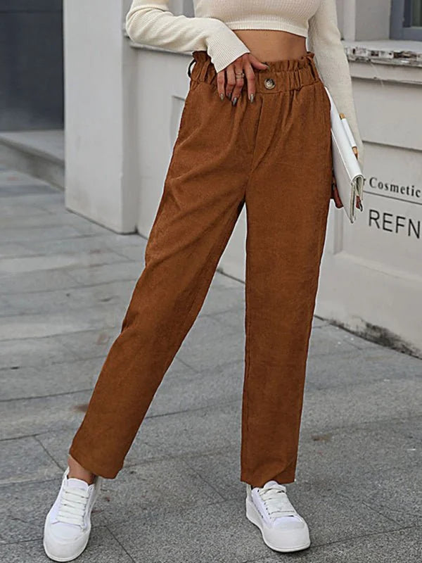 Brown corduroy pants with a paperbag waist and white sneakers, shown on a model.