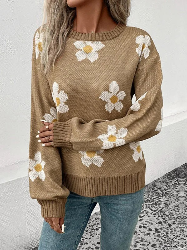Tan acrylic sweater with a white and yellow floral pattern and ribbed cuffs and hem.