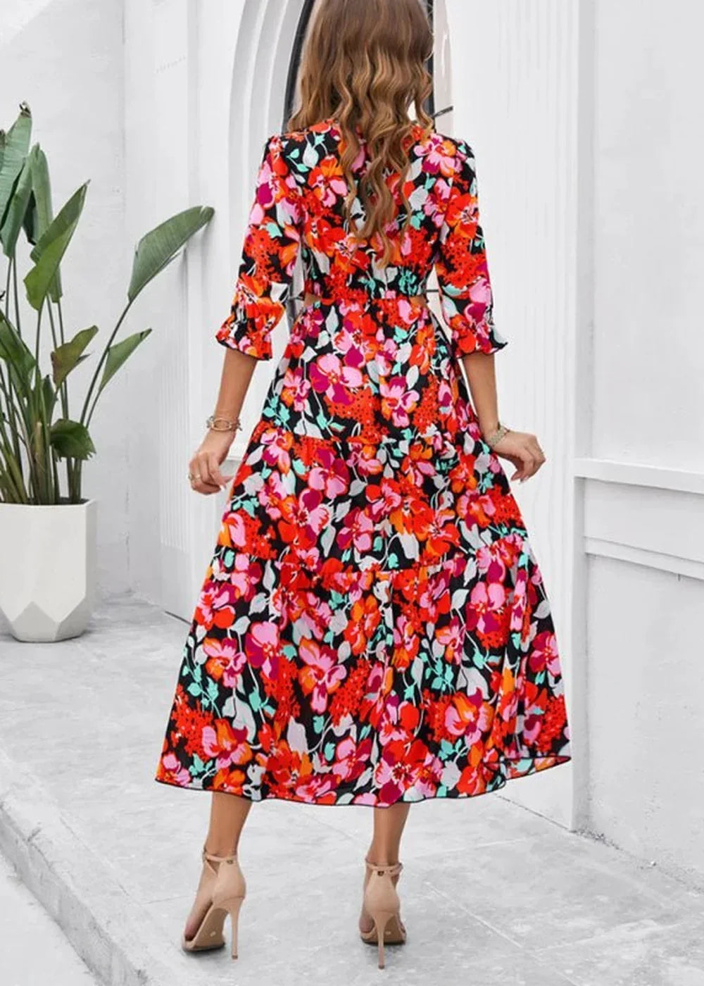 Red floral print midi dress with ruffled sleeves and tiered skirt, shown from the back.