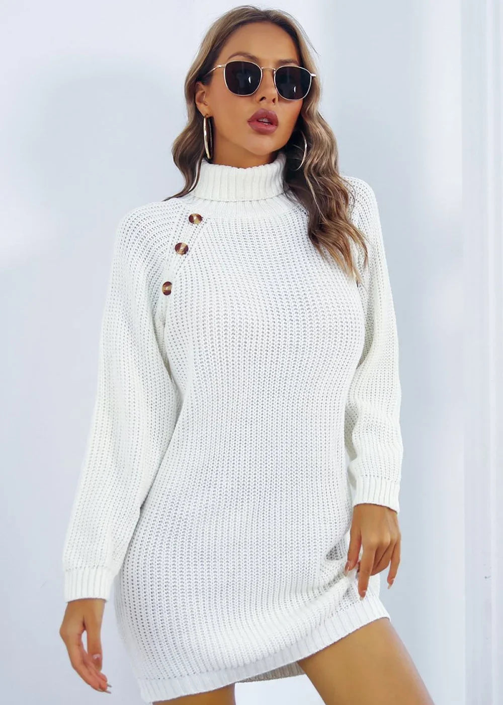 White acrylic knit turtleneck sweater dress with three button details on the shoulder.
