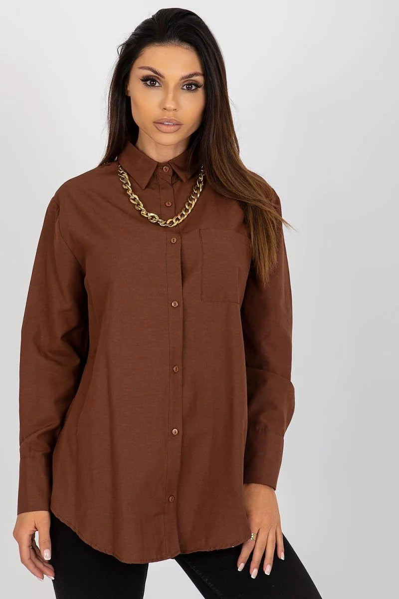 Model in a loose-fit, brown cotton-blend collared shirt with a gold chain necklace and a chest pocket.