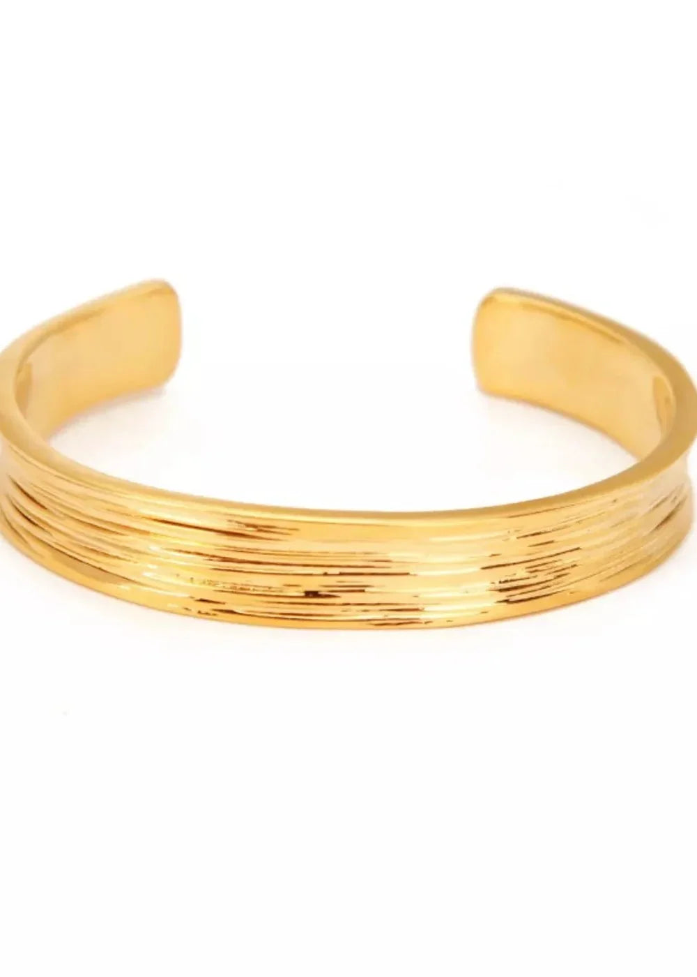Gold cuff bracelet with textured horizontal lines and open ends.
