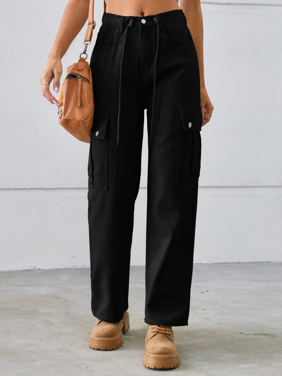 Black cargo pants with a drawstring waist and tan platform shoes on a model.