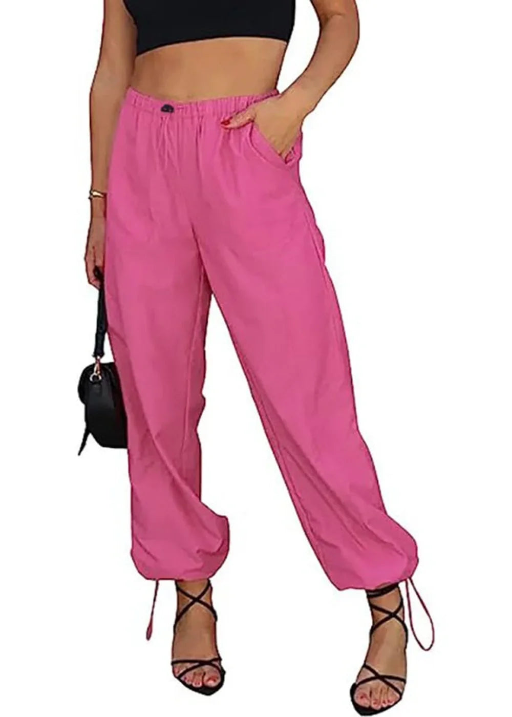 Bright pink high-waisted pants with drawstring ankles on a model.
