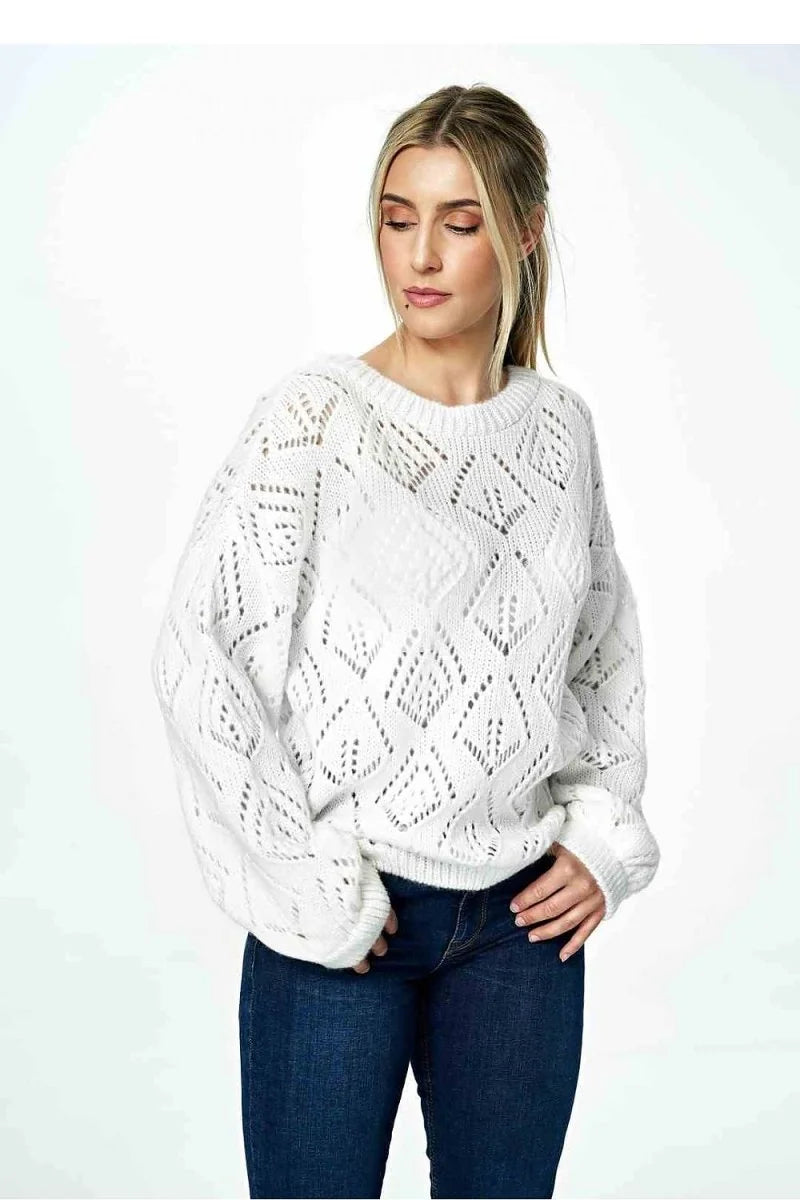 White open-knit sweater with diamond pattern, long sleeves, and crew neck on model.