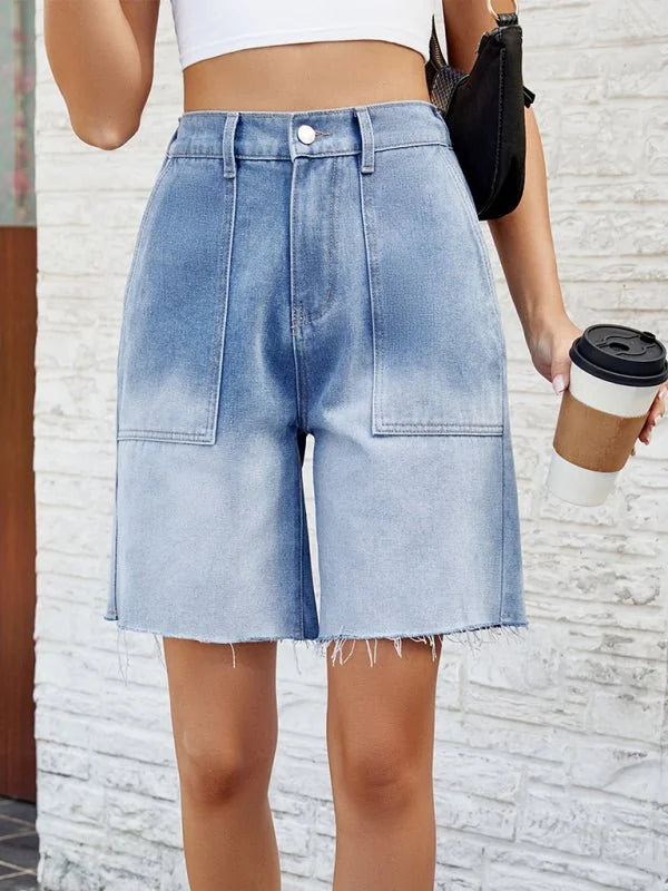 Light wash denim shorts with frayed hem and front pockets.