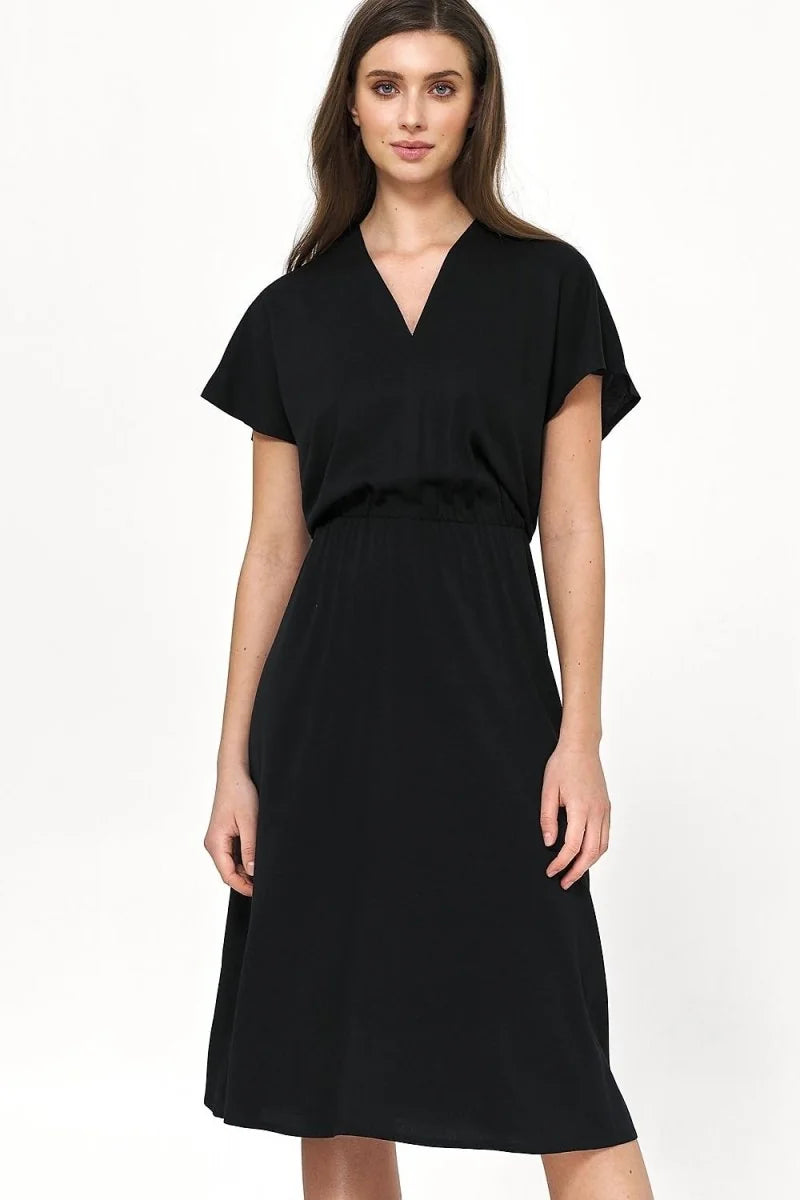 Black short-sleeve V-neck dress with cinched waist, on model.