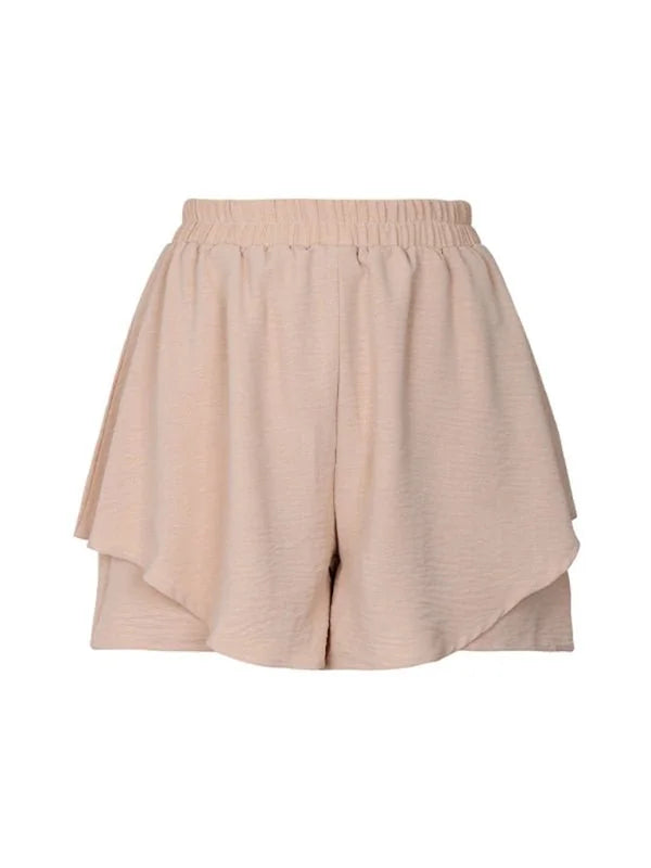 Light beige ruffled shorts with an elastic waistband and textured fabric, shown on a white background.