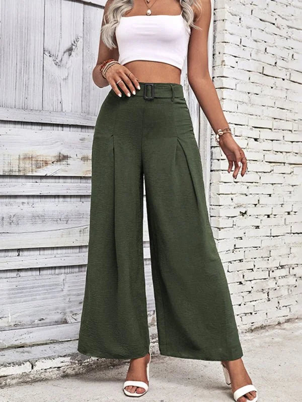 Olive green wide-leg pants with a textured fabric, pleated front, and belted waist on a model.