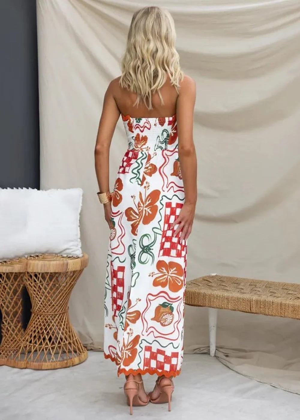 Strapless white maxi dress with orange floral and red checkered print, scalloped hem.