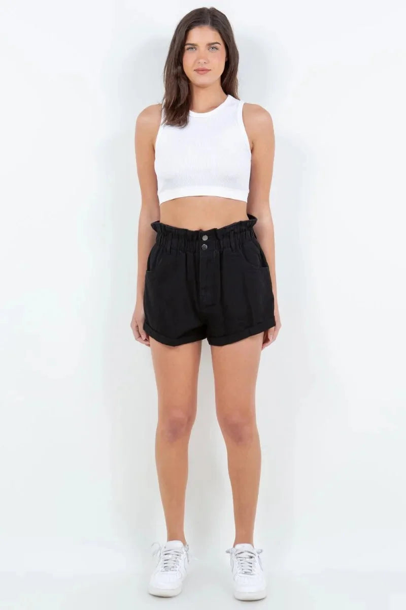 Black paperbag waist denim shorts with button closure on model, 100% cotton.