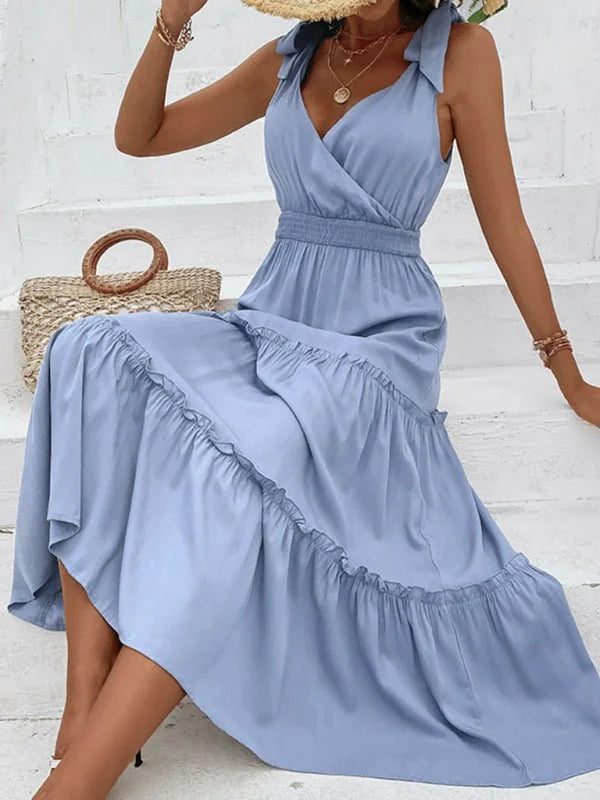 Light blue rayon maxi dress with ruffled tiers and tie straps, on model.
