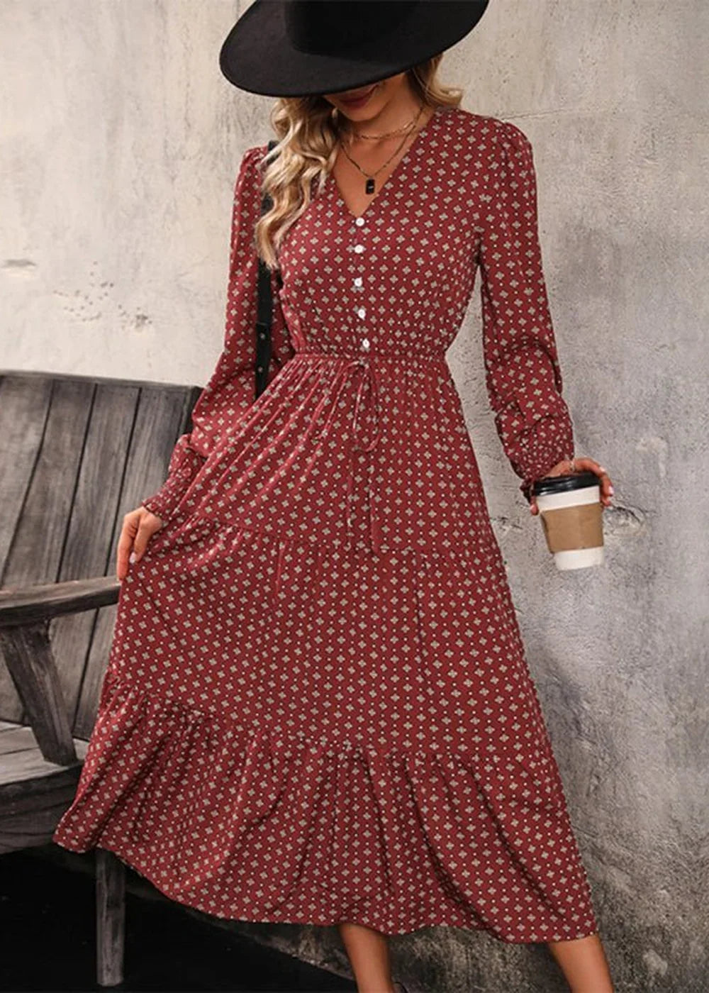Red dress with a white diamond print, v-neck, and long sleeves.