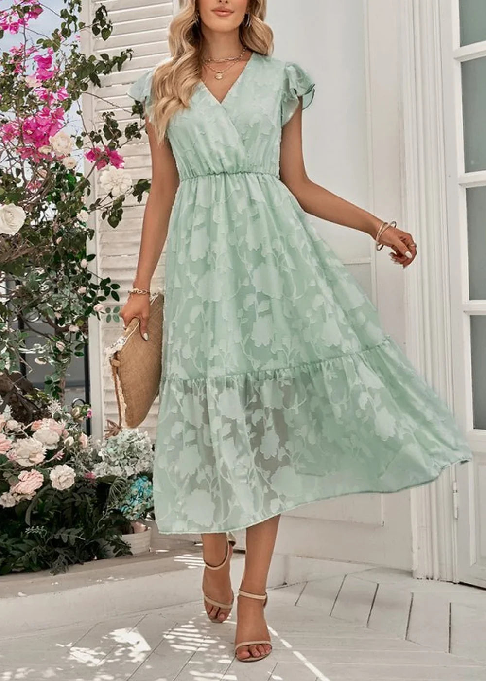 Light green floral print midi dress with flutter sleeves and tiered skirt.