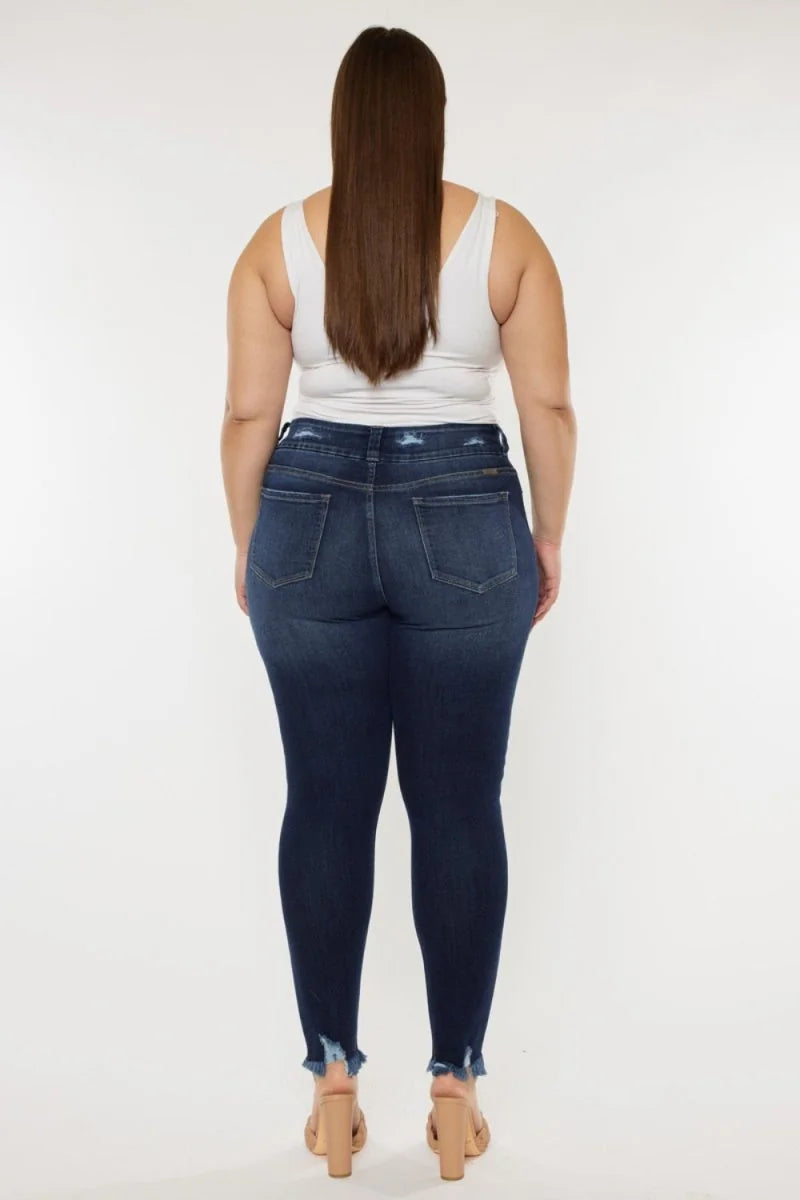 Dark wash denim jeans with frayed hem, showing back view on model.