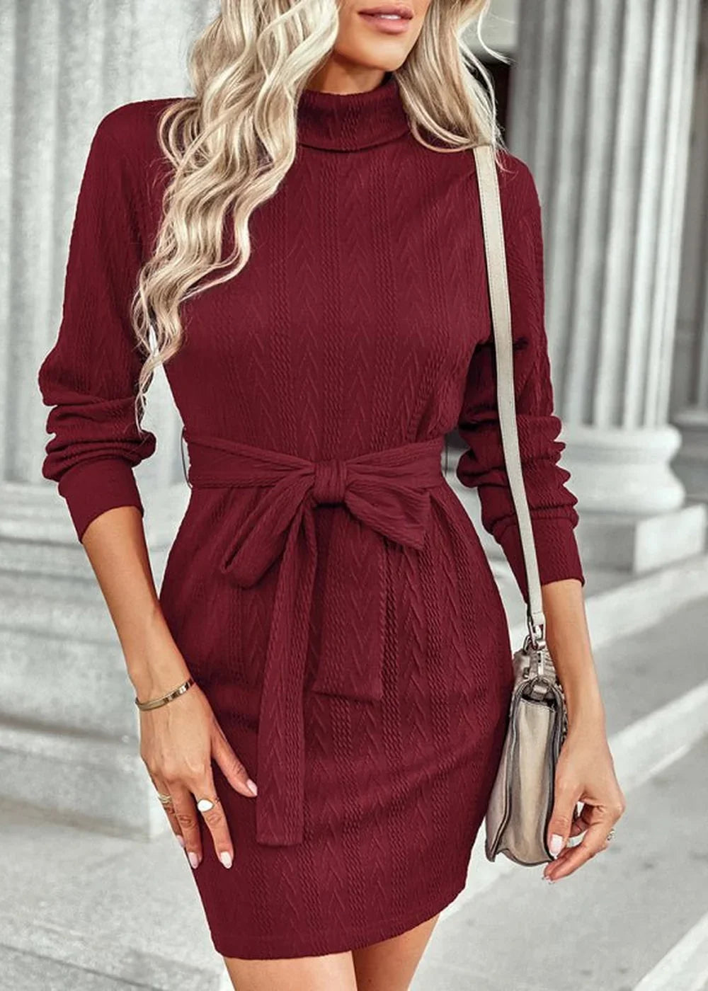 Burgundy textured knit turtleneck dress with a self-tie belt, long sleeves, and a fitted silhouette.
