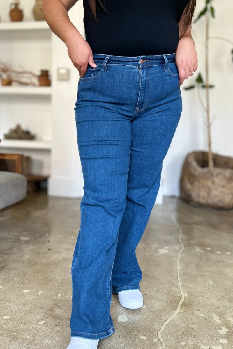 Medium wash denim jeans with a regular fit and slight flare at the hem.