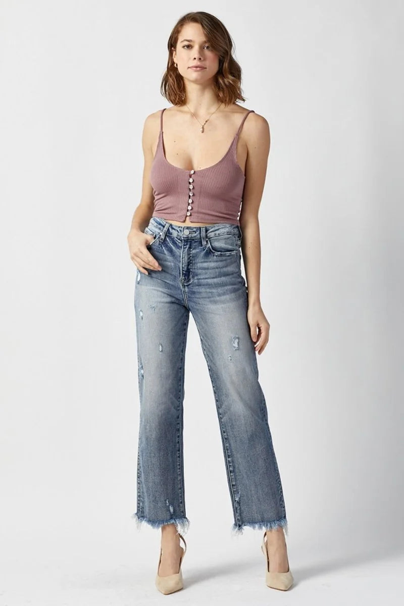 Light wash distressed denim jeans with a frayed hem and a slightly stretchy fit on a model.