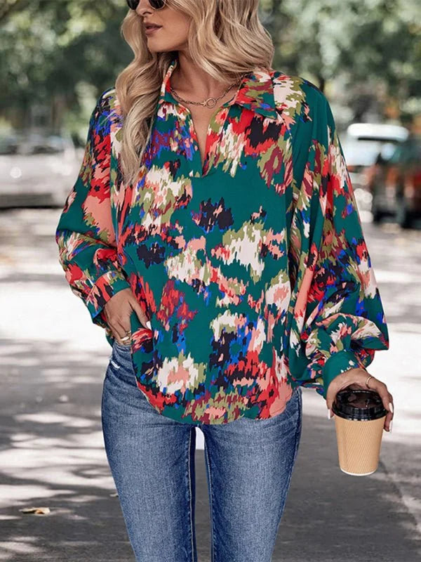 Green long-sleeve collared shirt with a vibrant abstract floral print in red, pink, blue, and white.