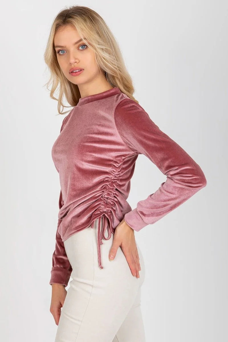 Dusty rose velvet top with ruched side detail and drawstring, on model.
