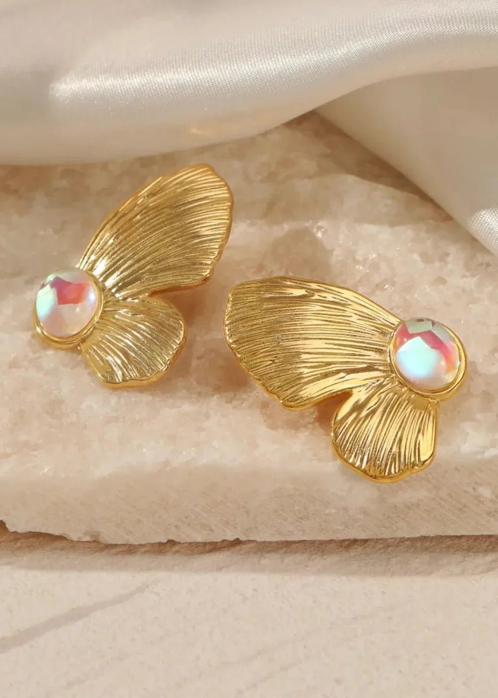 Gold-plated fan-shaped earrings with iridescent, pearly stones.