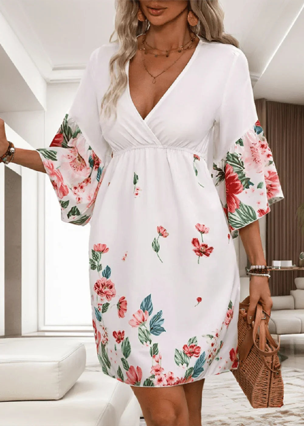 White floral print day dress with V-neck and bell sleeves, on a model.