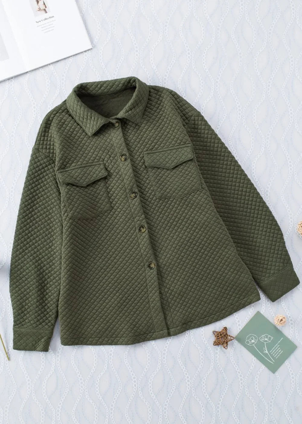 Olive green quilted shacket with button front and two chest pockets.