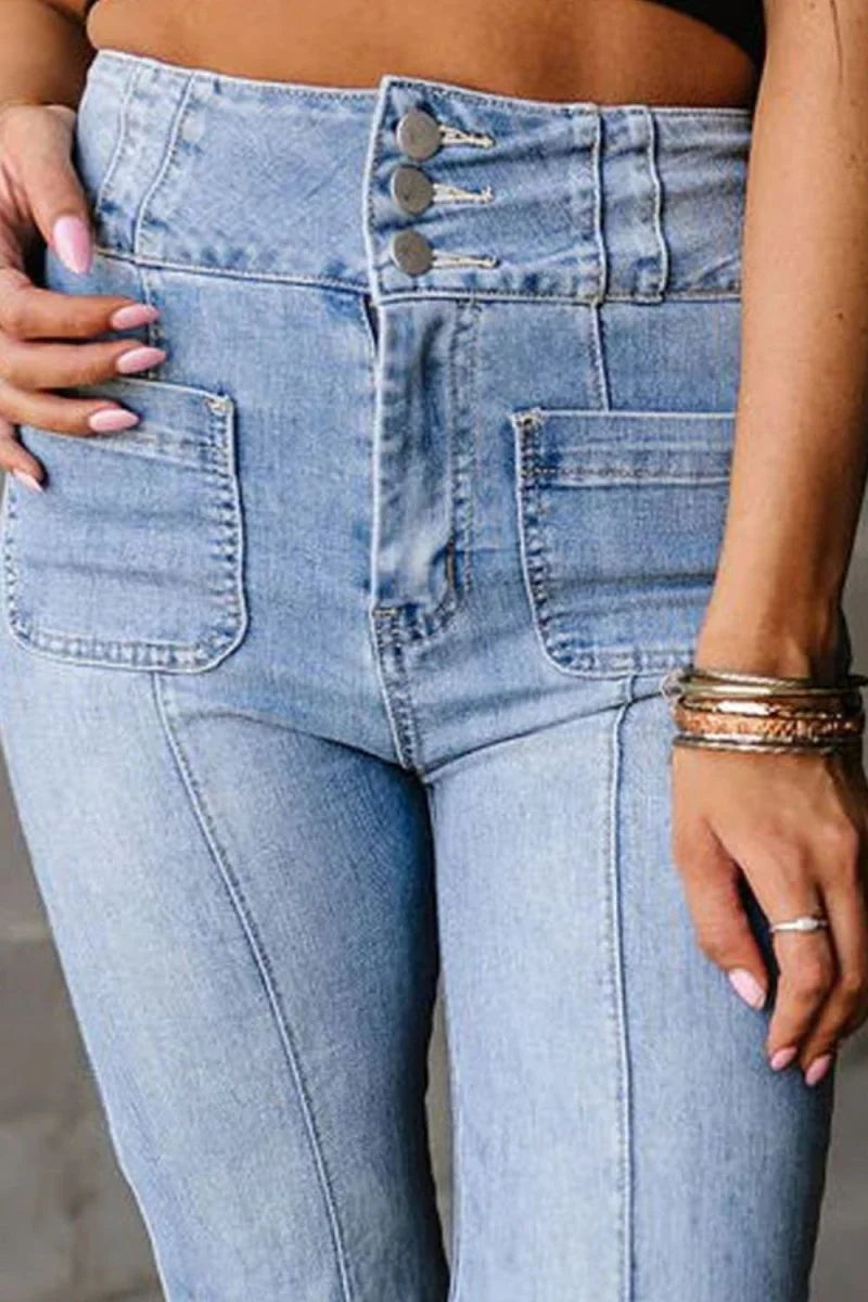 Close-up of light blue high-waisted jeans with button fly and pocket details.