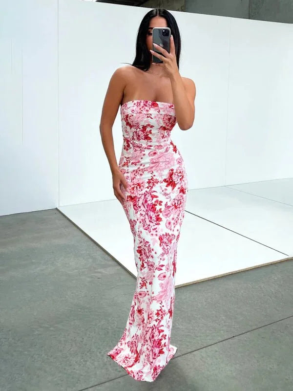 Full length strapless maxi dress with a vibrant pink and red floral pattern on a white background.