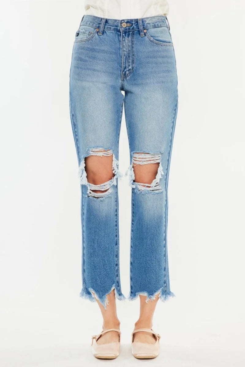 Light wash distressed denim jeans with frayed hem and raw edges at the knees.