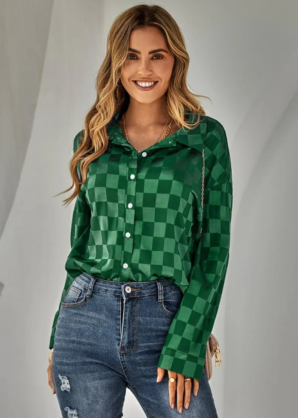 Green checkered satin shirt with white buttons, worn by a model with blue jeans.
