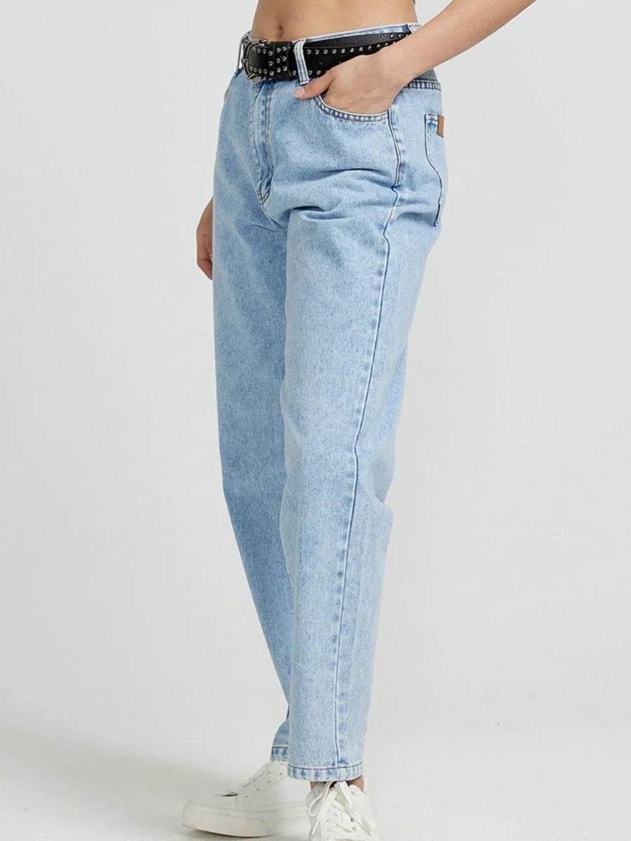 Light wash, relaxed fit denim jeans with a black studded belt, on model.