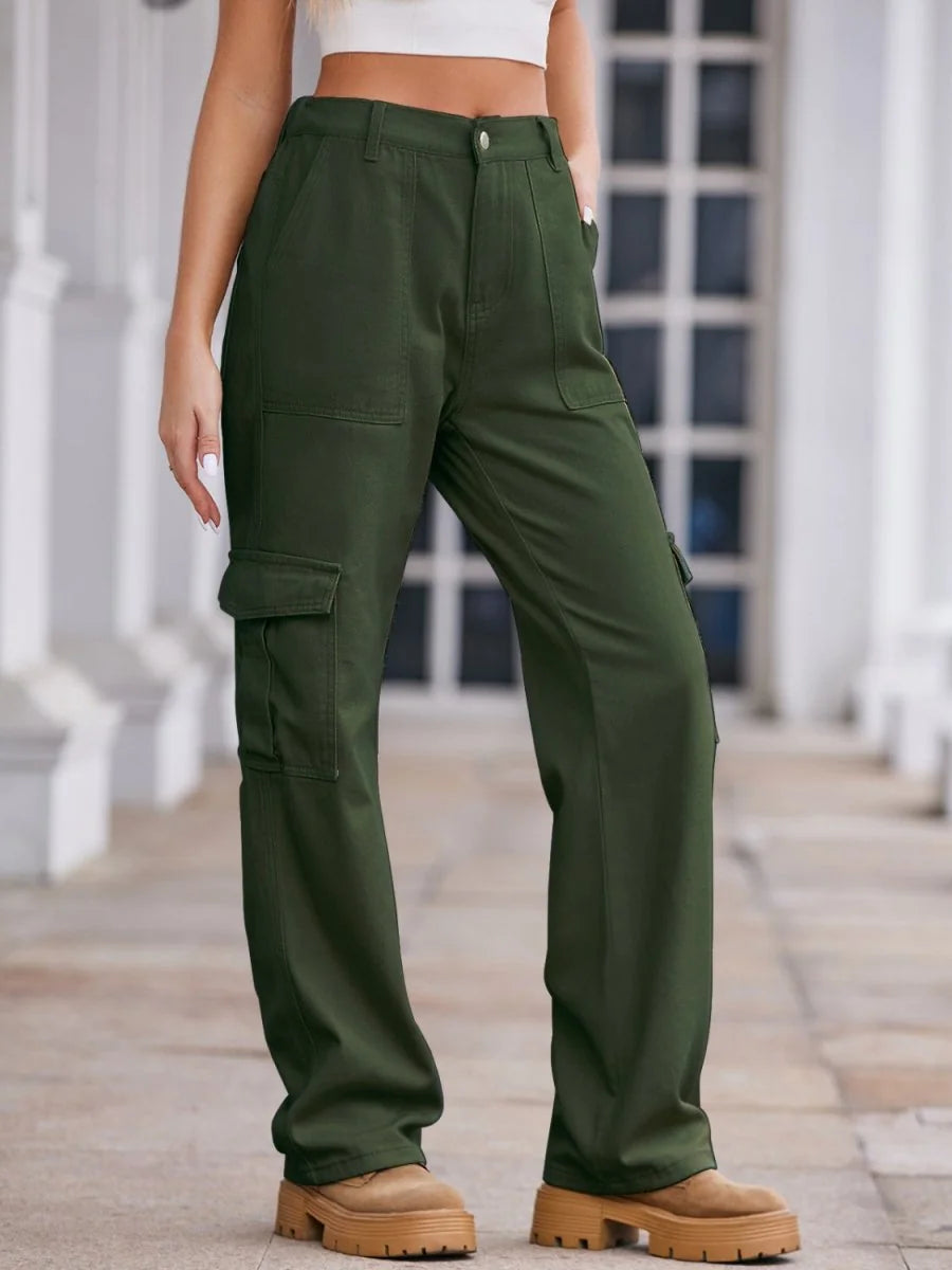 Model wearing olive green cargo pants with large side pockets and tan platform boots.