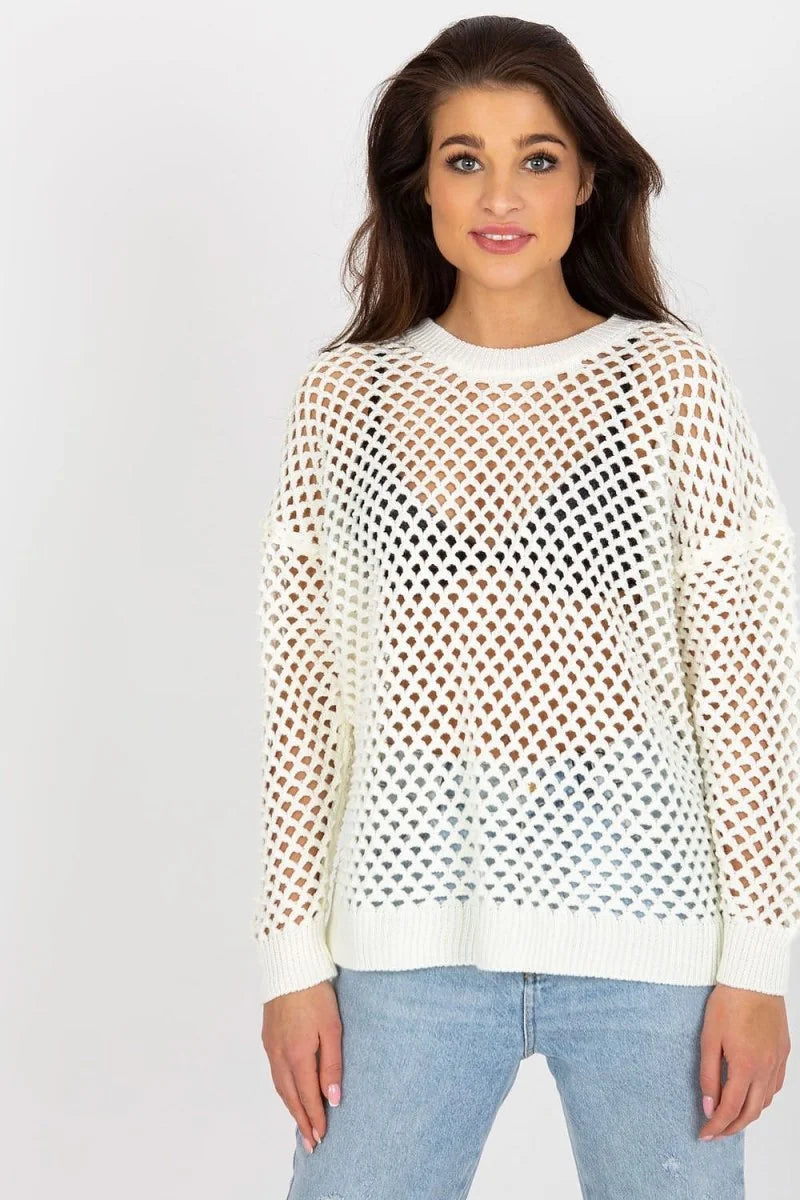White open knit sweater with crew neck and long sleeves, worn over a black bra and light wash jeans.