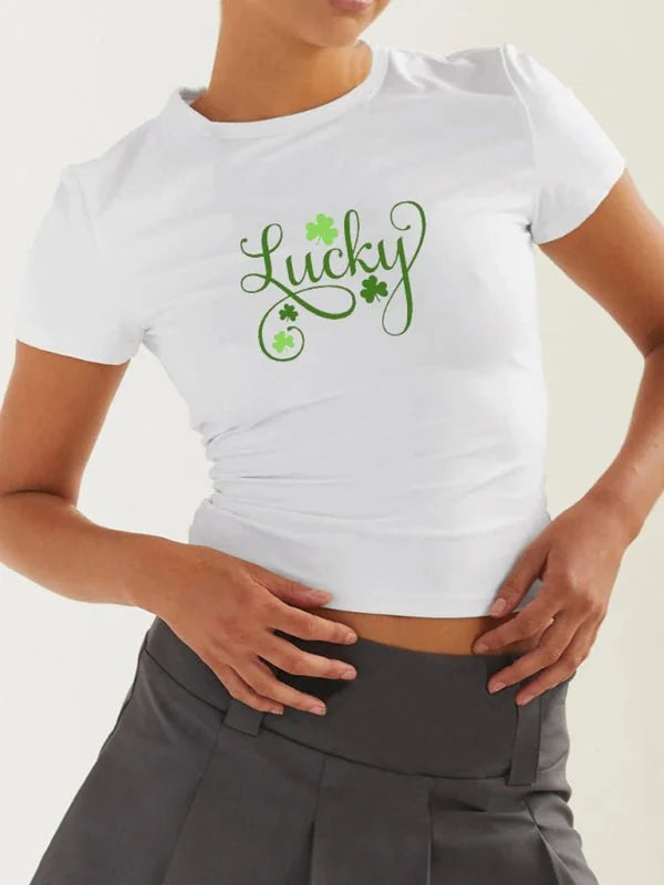 White fitted t-shirt with green "Lucky" print and shamrocks.