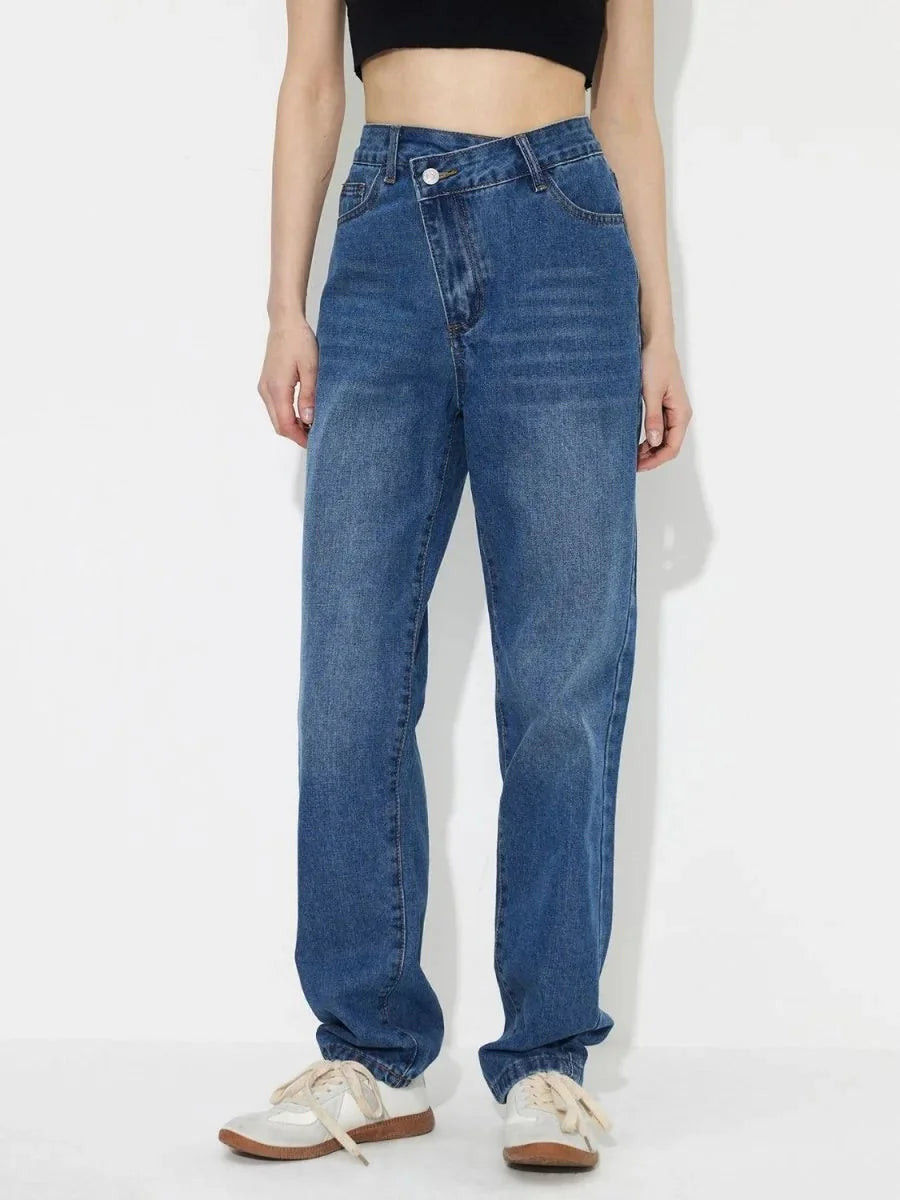 Medium blue denim jeans with a unique crossover waistband and a regular fit.