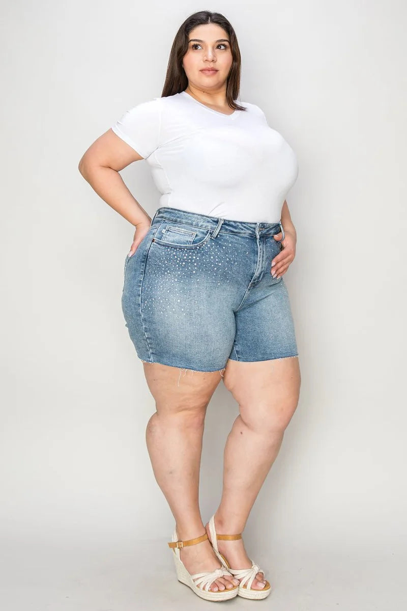 Light wash denim shorts with rhinestones on the pockets and a frayed hem.