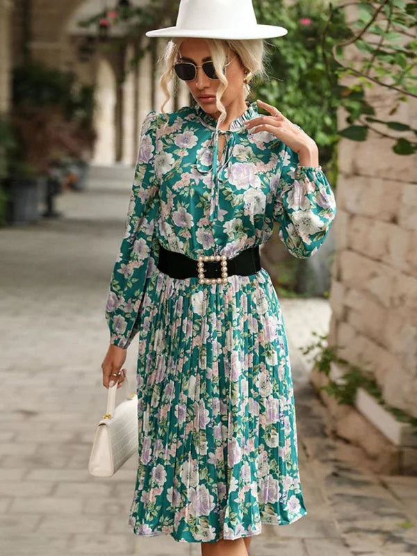 Green floral print midi dress with pleated skirt and black pearl-embellished belt.