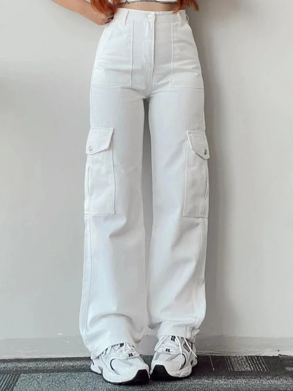 White relaxed fit cargo pants with large side pockets, cuffed ankles, and white sneakers.