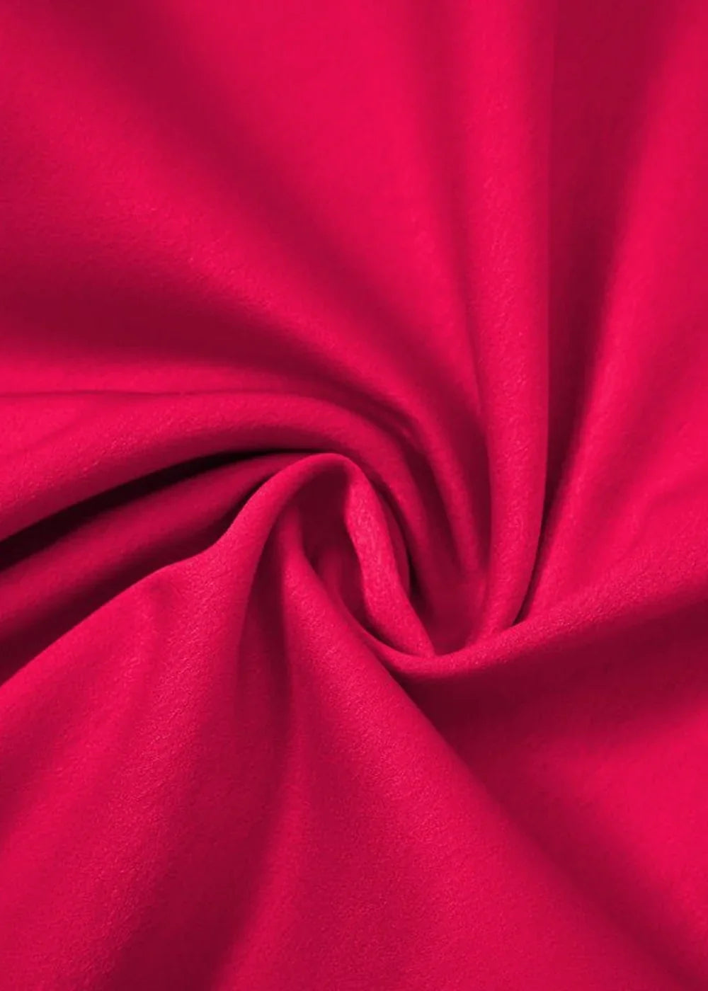 Close-up of bright pink polyester fabric with a soft texture and swirling folds.