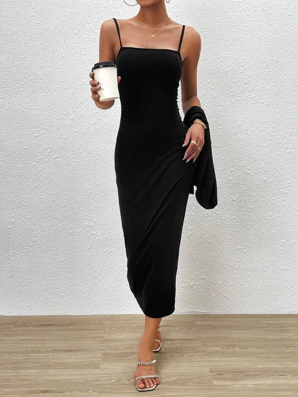 Sleek black maxi dress with spaghetti straps and a flattering straight neckline, worn with sparkly heeled sandals.