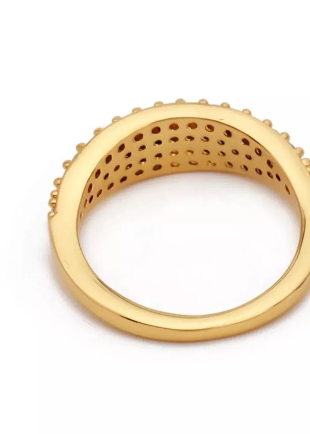 Gold ring with raised bead details and a patterned interior, showcasing a polished finish.