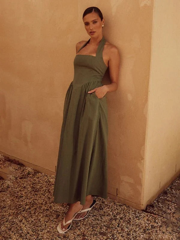 Olive green halter neck midi dress with pockets, on model.