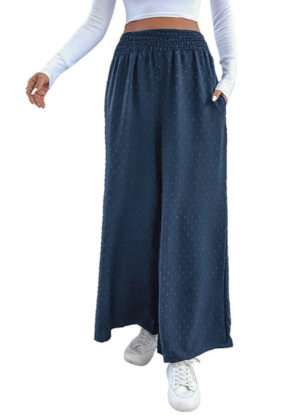 Navy blue wide-leg pants with a subtle dot pattern and elastic waistband, worn with white sneakers.